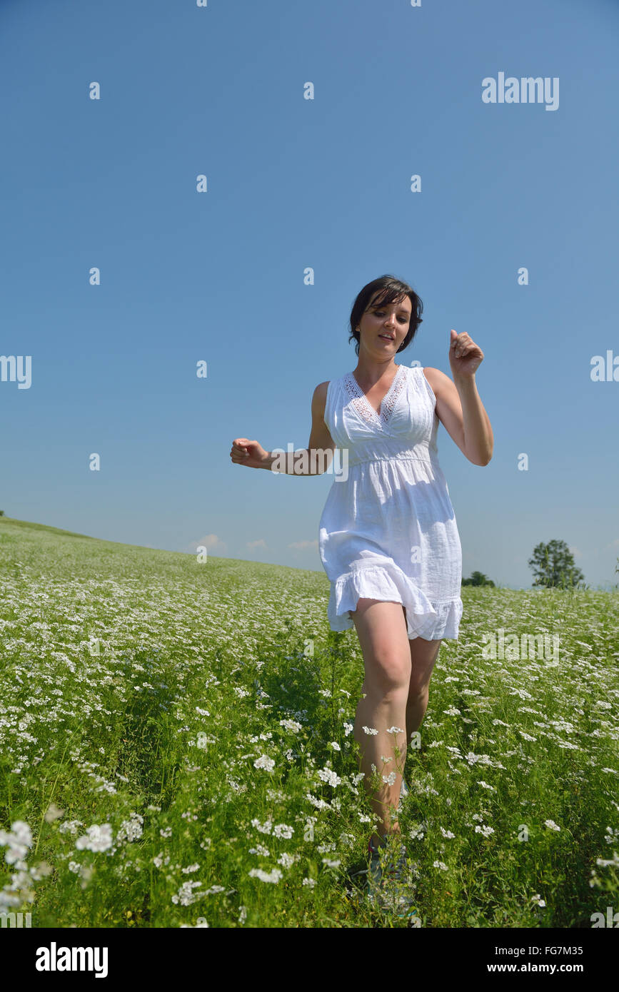 Young happy woman in green field Stock Photo - Alamy