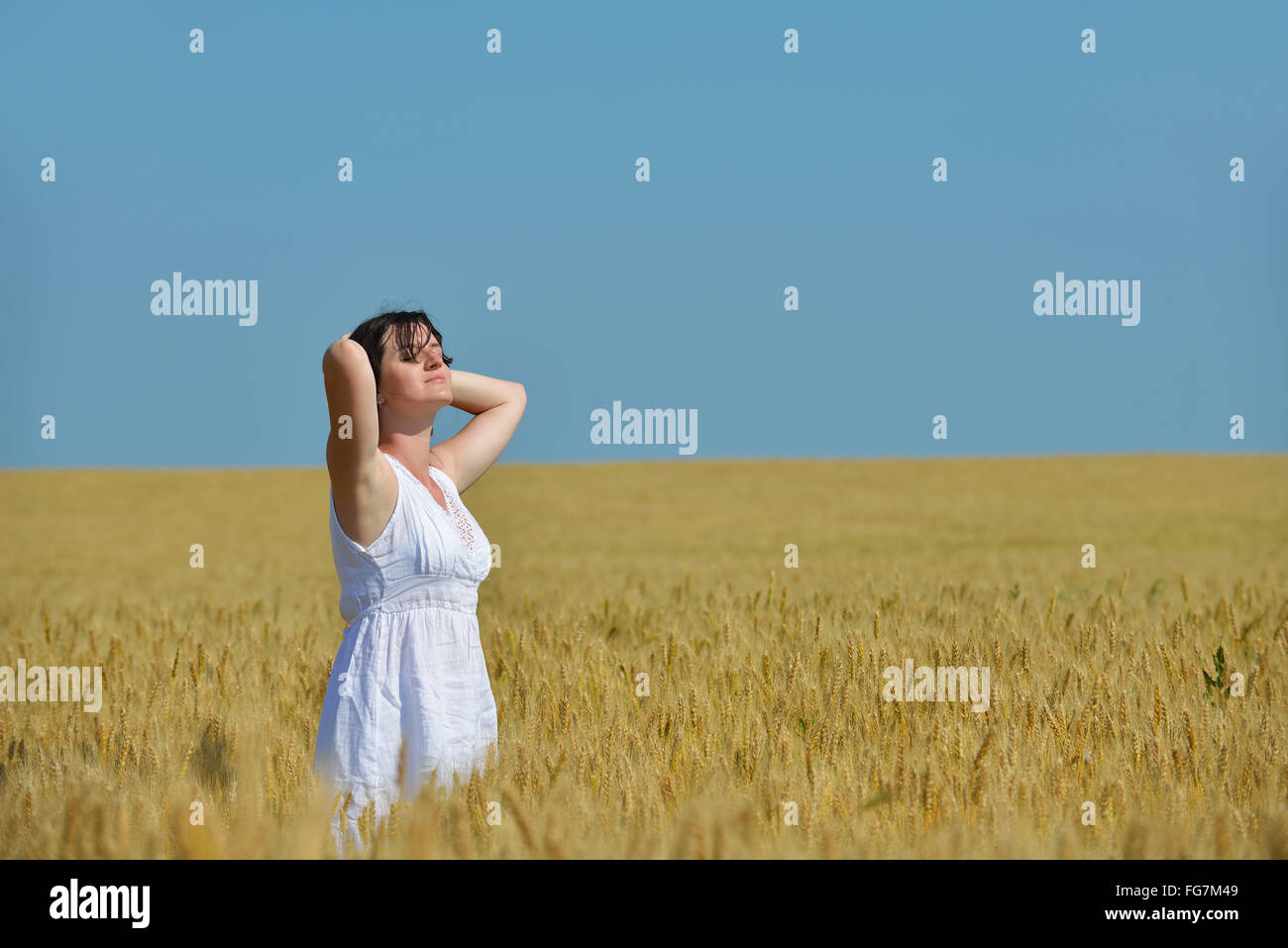young woman in wheat field at summer Stock Photo - Alamy