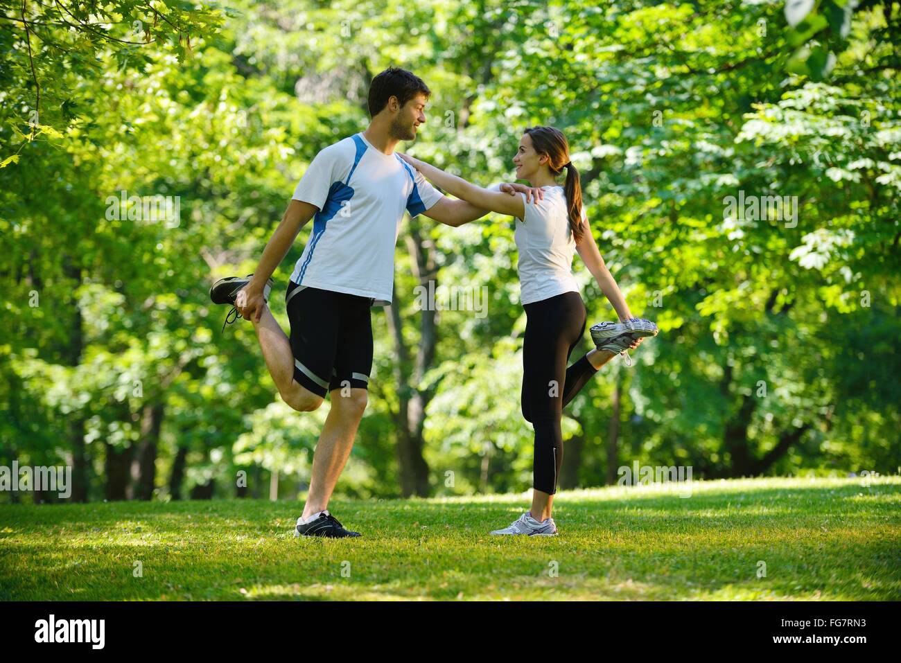 Couple doing stretching exercise after jogging Stock Photo Alamy