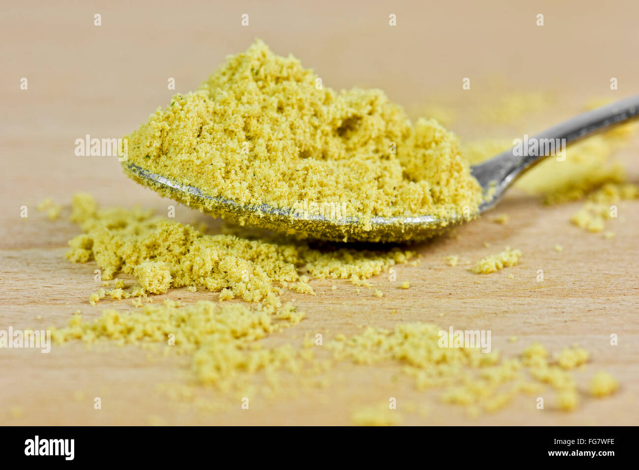 Spoonful of vegetable bouillon stock powder on chopping board Stock Photo