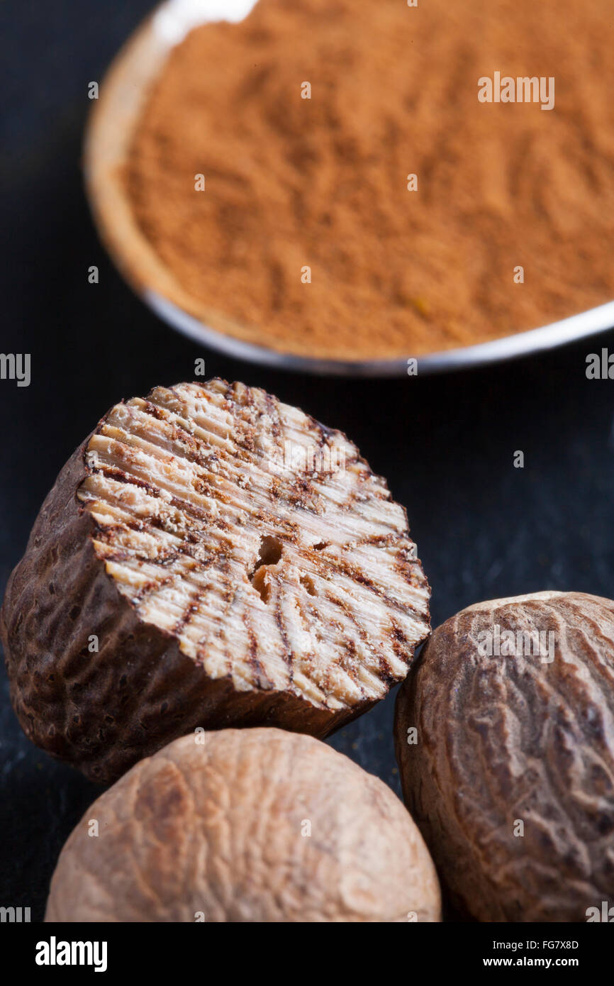 curry nutmeg paprika ginger cardamom fresh powder spices blend on black