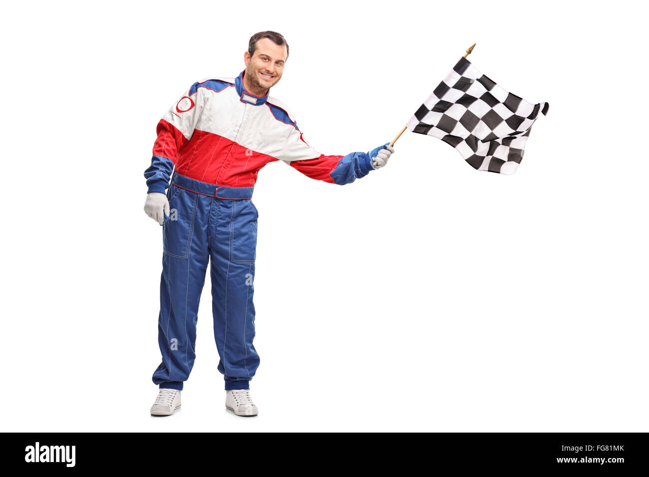 Studio shot of a young male car racer waving a checkered race flag isolated on white background Stock Photo