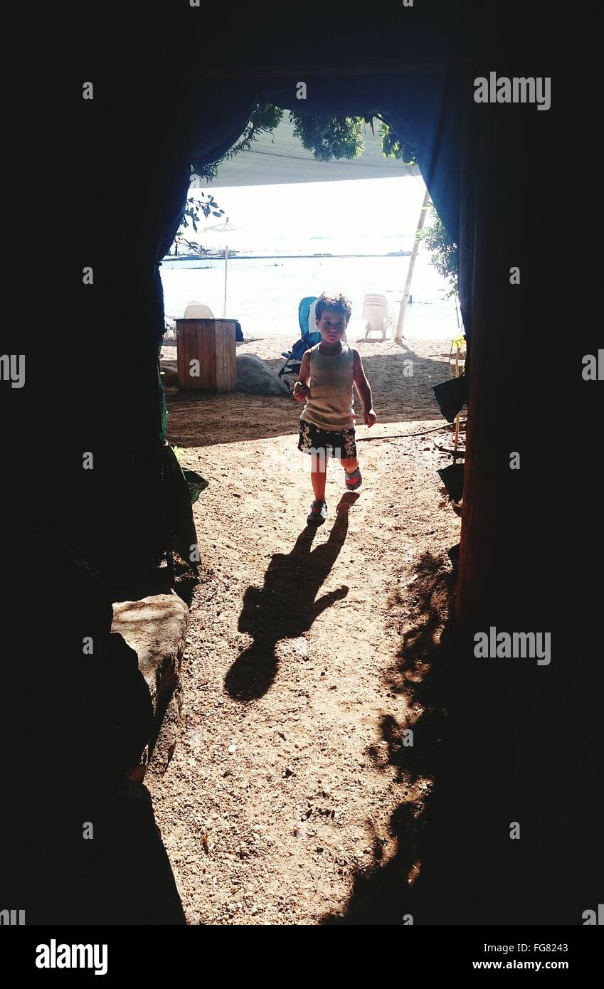 Boy Walking In Field Stock Photo