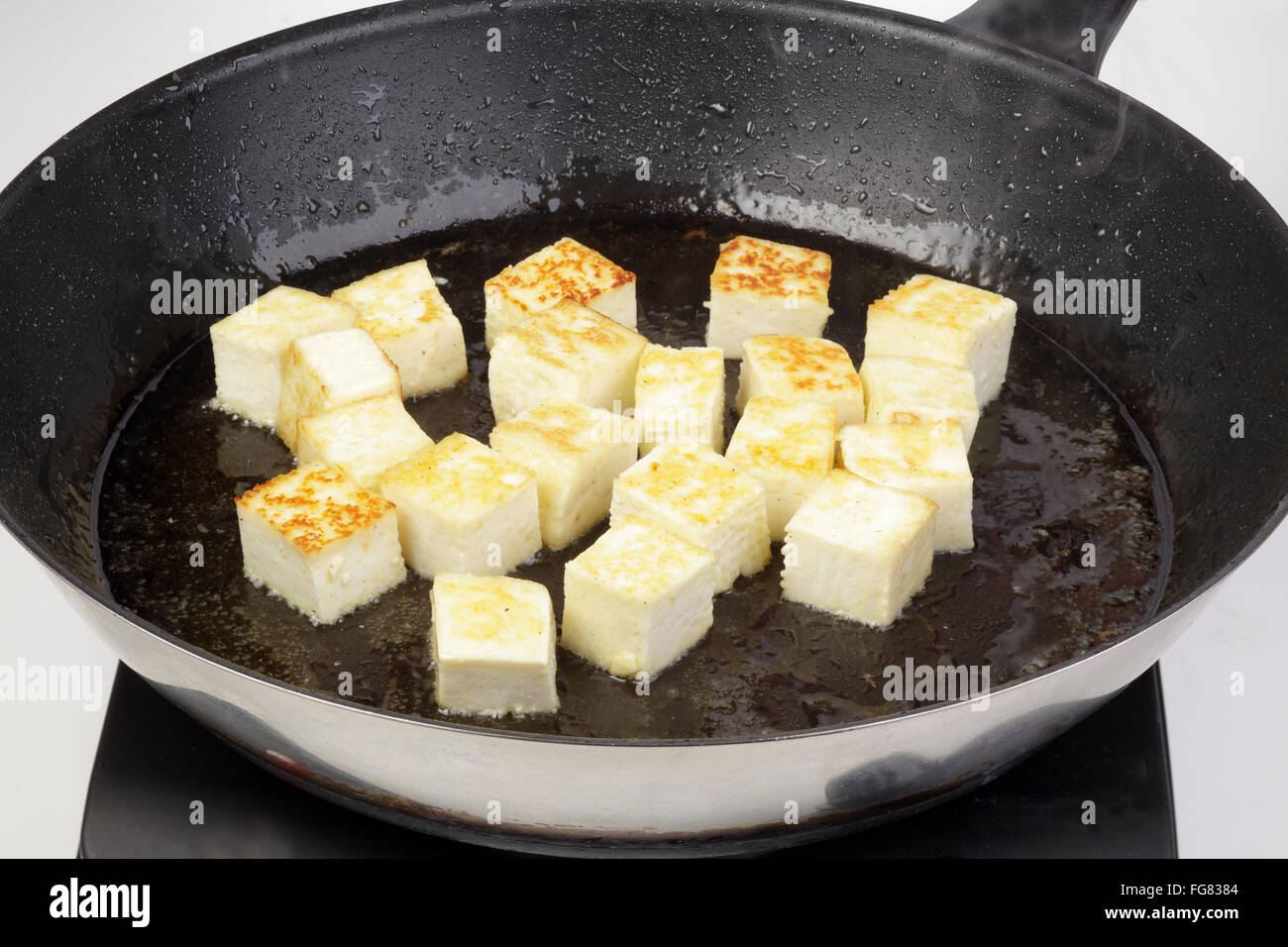 Paneer being fried Stock Photo