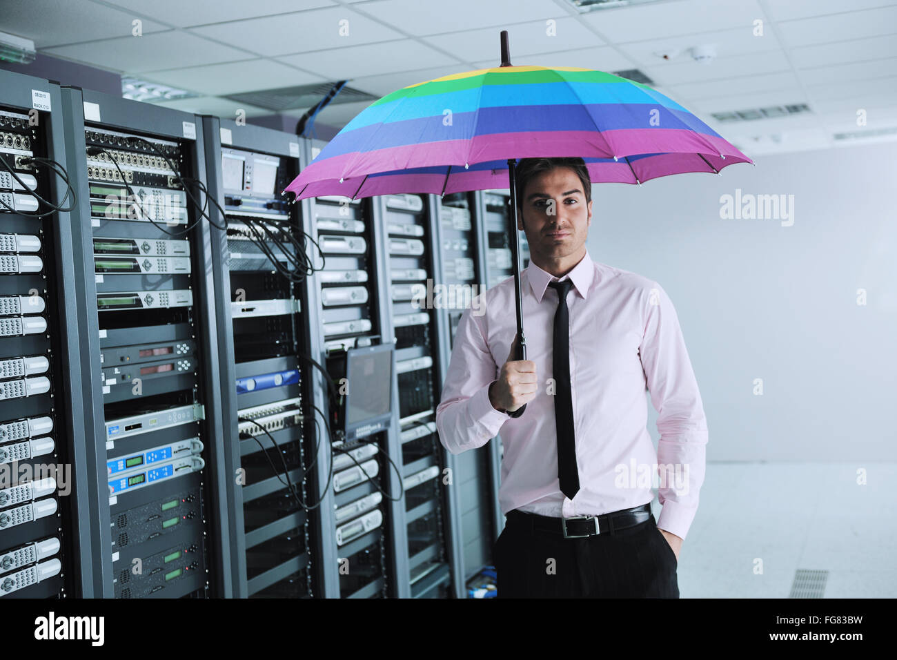 businessman hold umbrella in server room Stock Photo