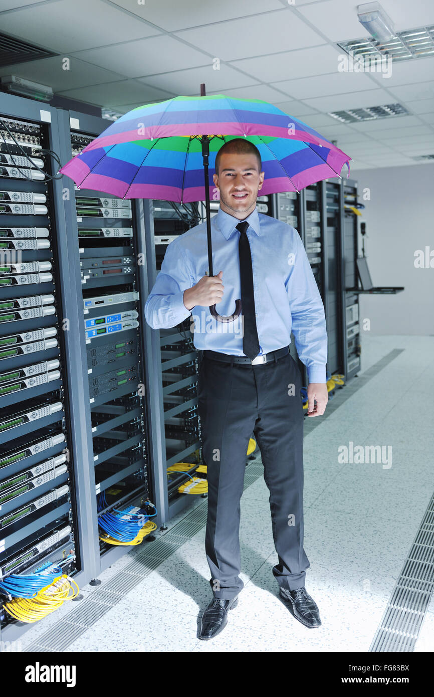 businessman hold umbrella in server room Stock Photo Alamy