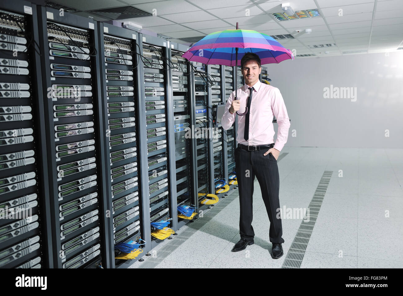 businessman hold umbrella in server room Stock Photo Alamy