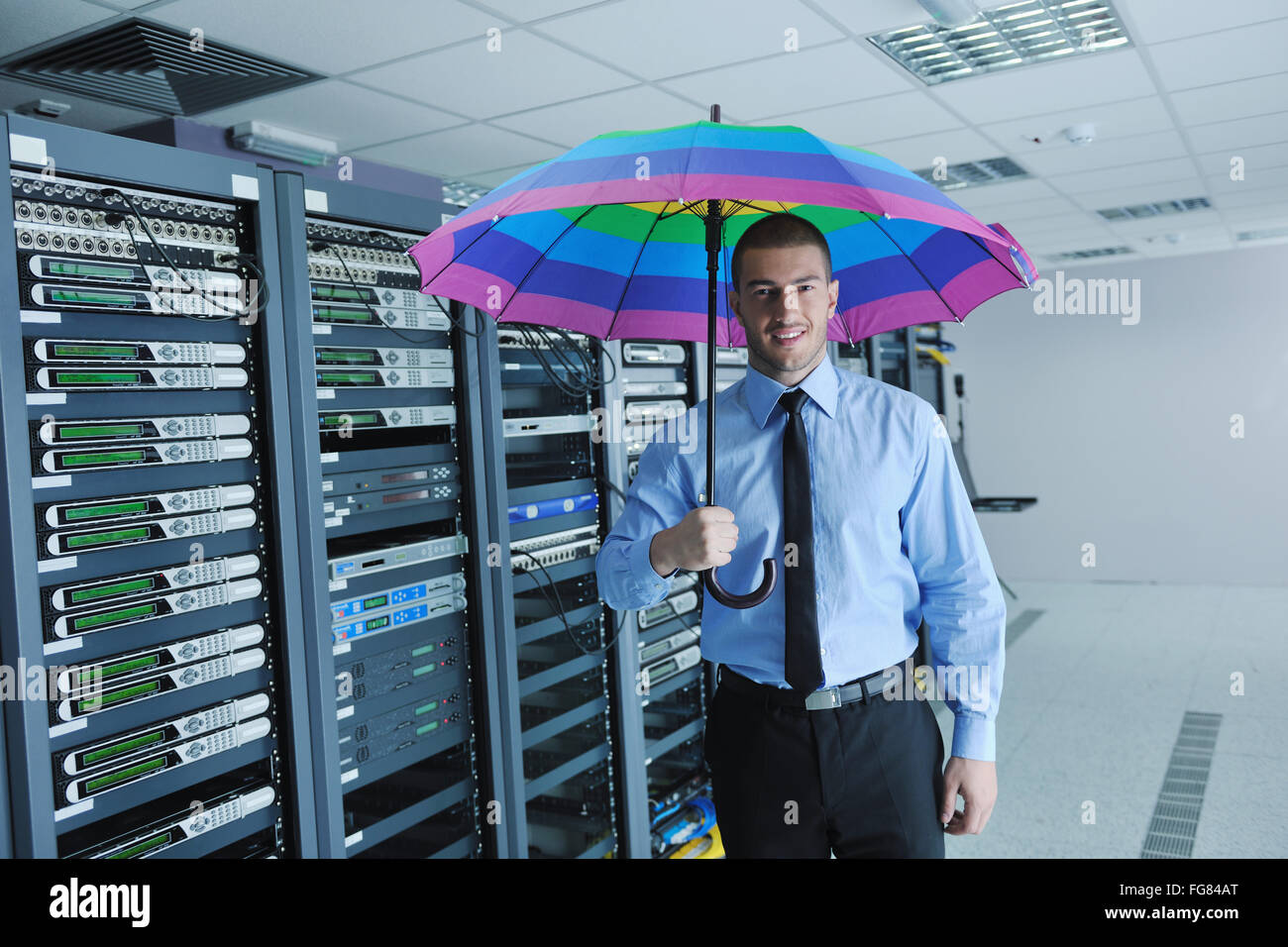 businessman hold umbrella in server room Stock Photo Alamy
