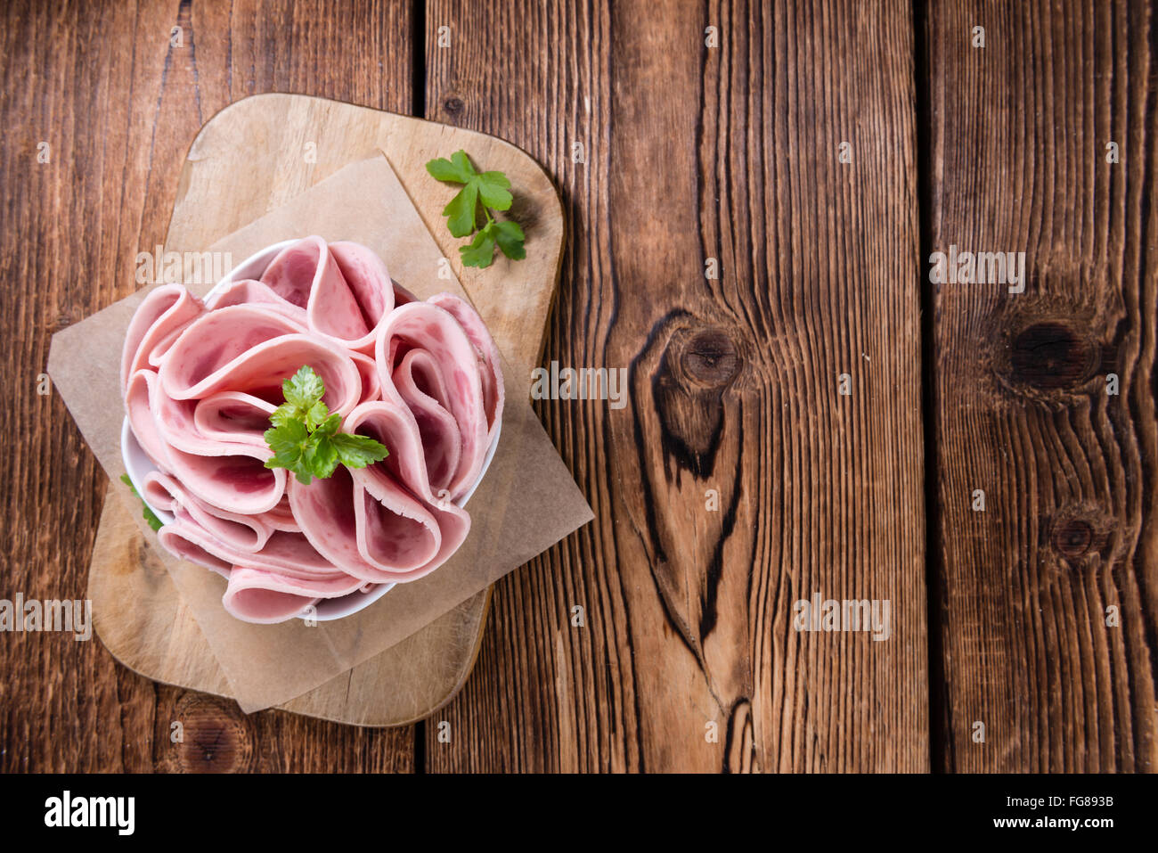 Cutted Ham Sausage on wooden background (selective focus) Stock Photo