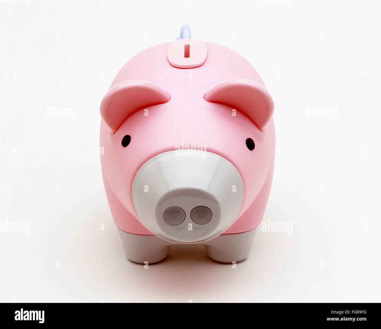 Pink piggy bank on white background, Surrey, England, United Kingdom Stock Photo
