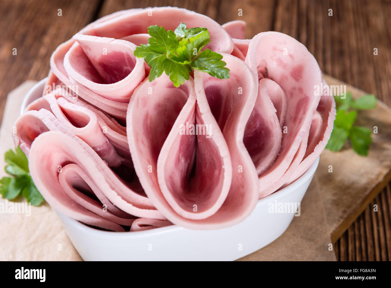 Cutted Ham Sausage on wooden background (selective focus) Stock Photo