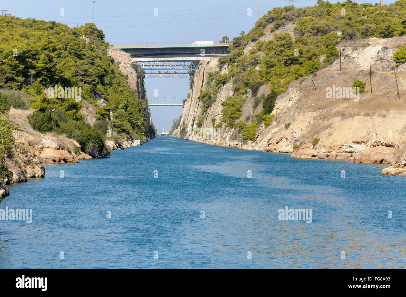 Boats passing through the Corinth canal which cuts through the isthmus separating the Peloponnese from Greece Stock Photo