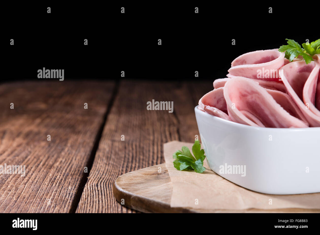 Old rustic wooden table with Ham Sausage (selective focus) Stock Photo