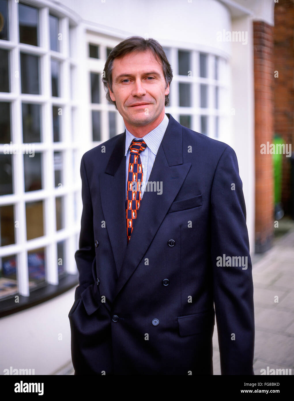 Professional business man in street, High Street, Sunninghill, Berkshire, England, United Kingdom. Stock Photo