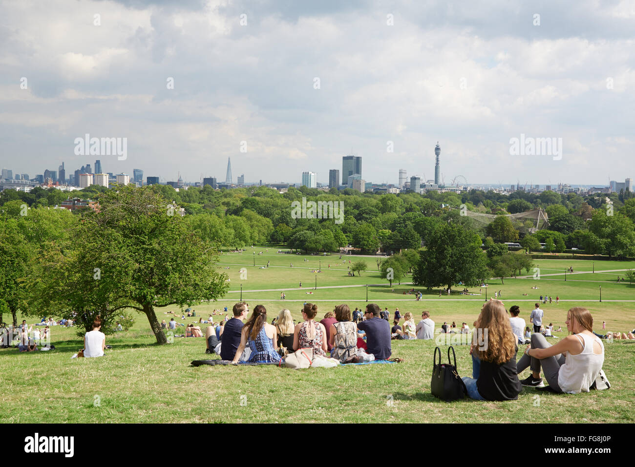 Primrose hill top with London city view and people relaxing in the park in London Stock Photo