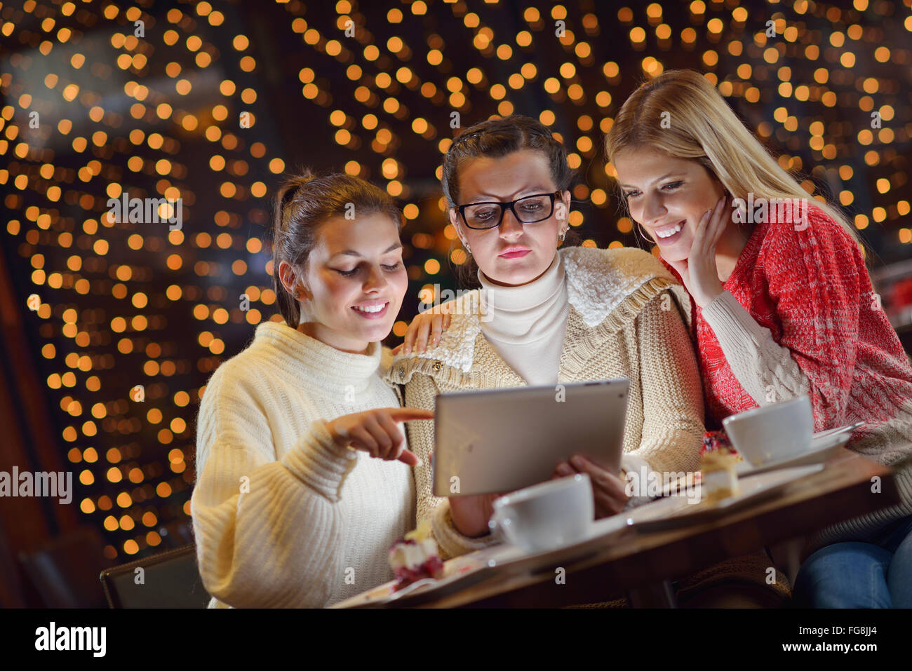 happy girls group looking at a pc tablet Stock Photo - Alamy