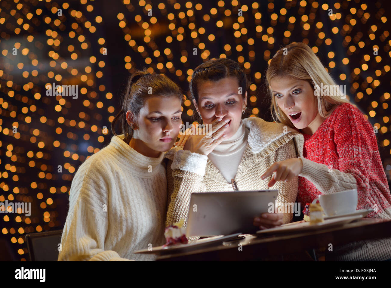 happy girls group looking at a pc tablet Stock Photo - Alamy