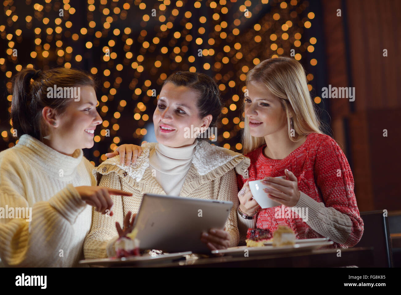 happy girls group looking at a pc tablet Stock Photo - Alamy
