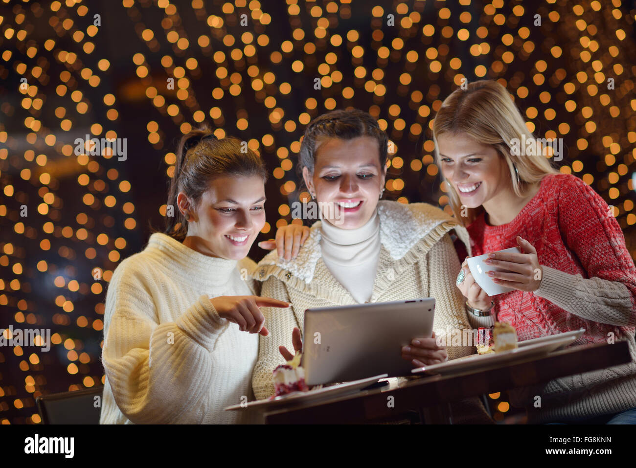 happy girls group looking at a pc tablet Stock Photo - Alamy