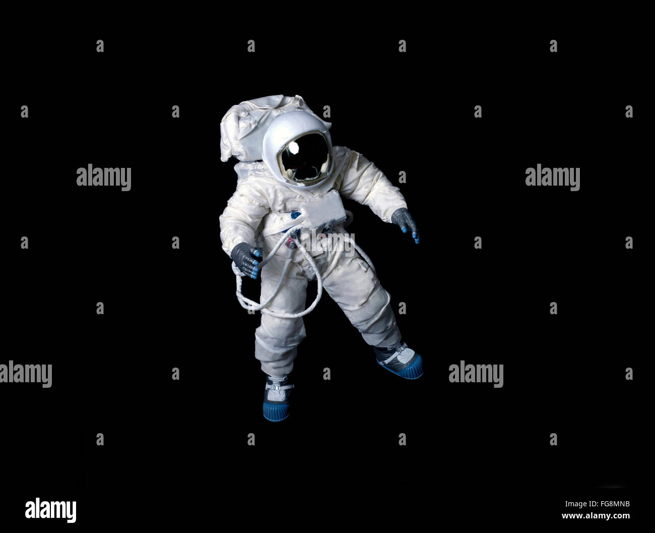 Astronaut wearing a pressure suit against a black background. Stock Photo