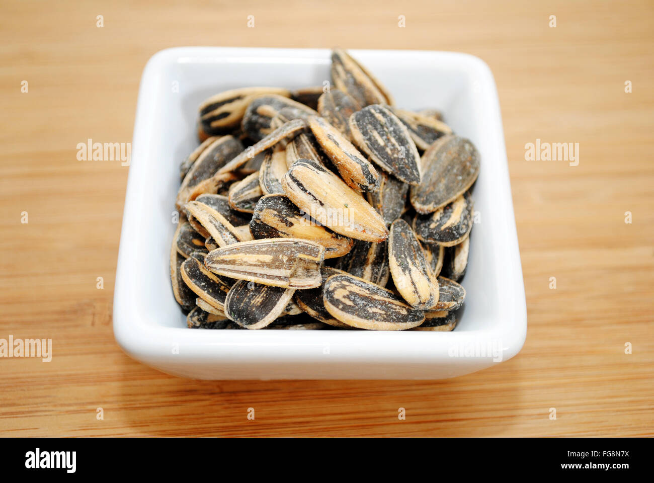 Ranch Flavored Sunflower Seeds in a White Square Bowl Stock Photo