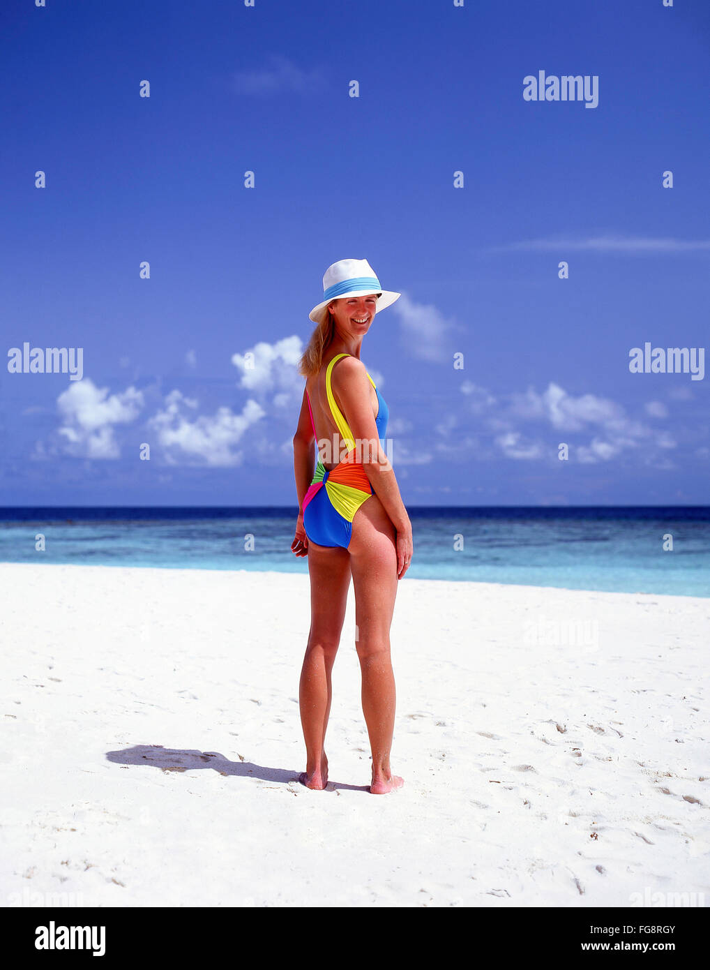 Young woman on tropical beach, Kuda Bandos, Kaafu Atoll, Republic of Maldives Stock Photo