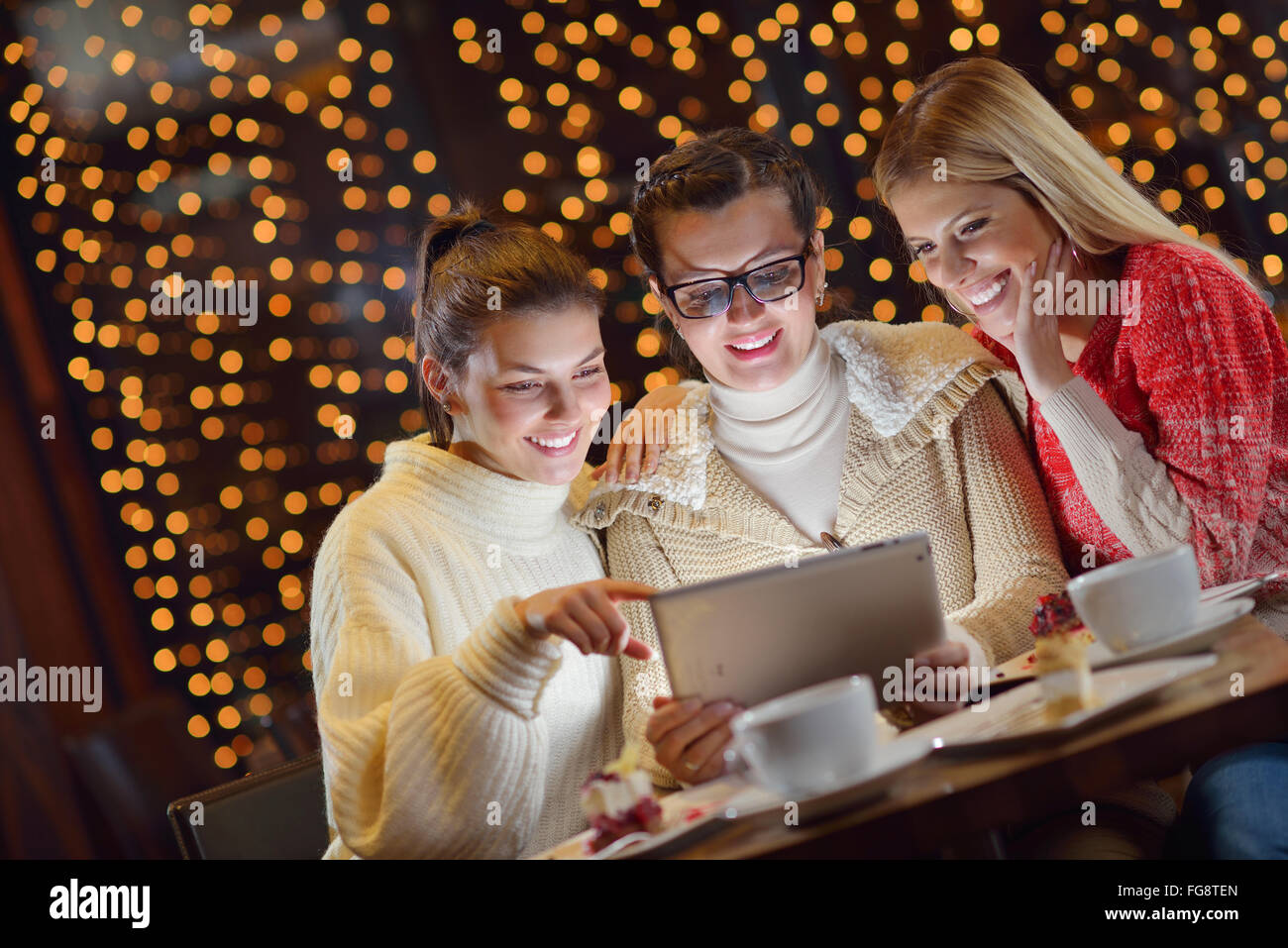 happy girls group looking at a pc tablet Stock Photo - Alamy