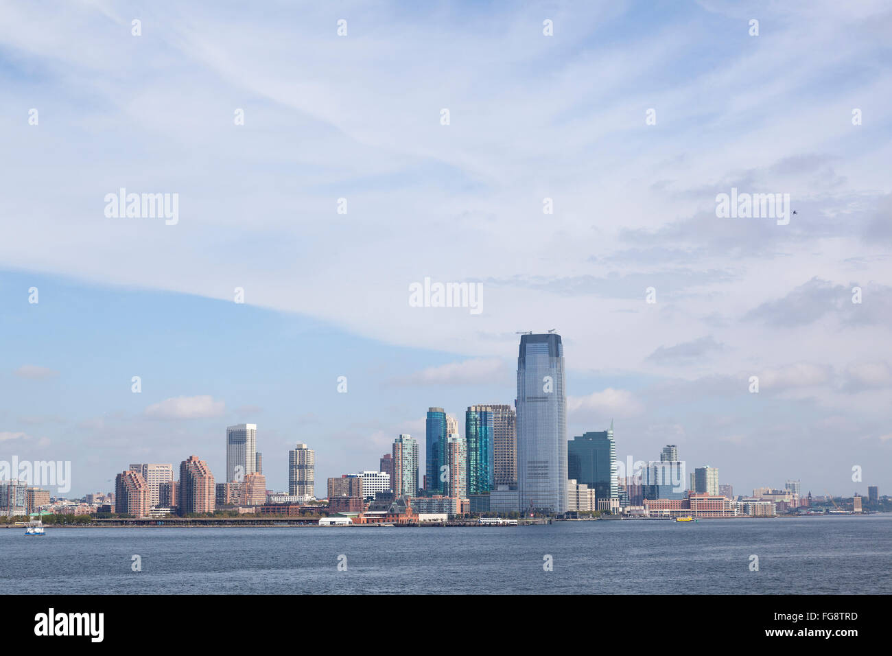 skyline of jersey city with blue sky and white clouds seen from the ...