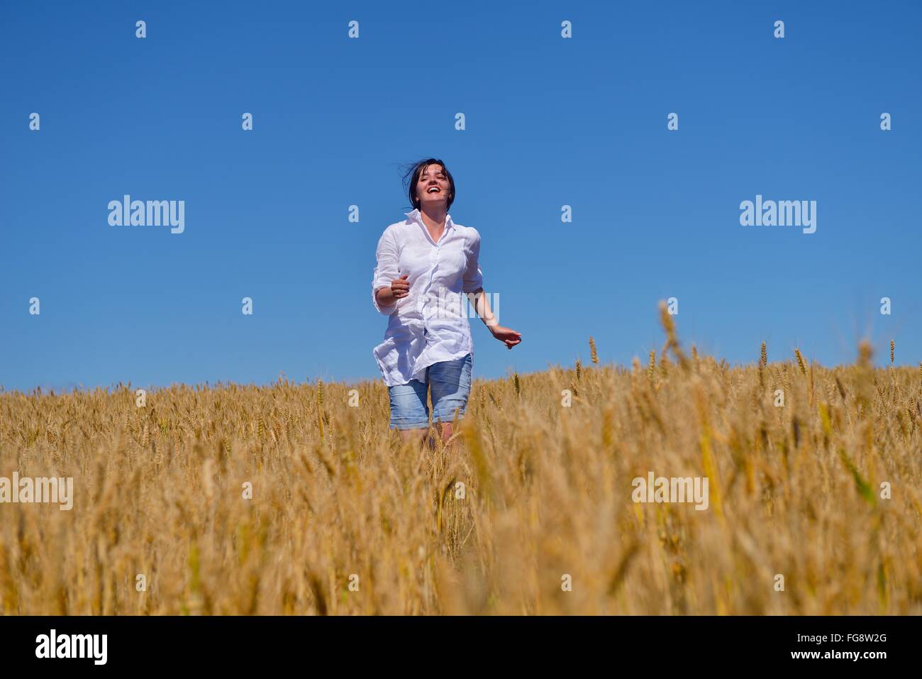 young woman in wheat field at summer Stock Photo - Alamy