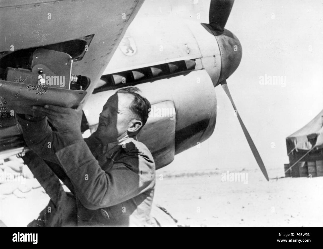 The Nazi propaganda picture shows the installation of a film camera on an airplane for the reporting about the North African front on an airport of the German Wehrmacht in North Africa. The photo was taken between 1941 and 1943, exact date unknown. Fotoarchiv für Zeitgeschichtee-  NO WIRE SERVICE - Stock Photo