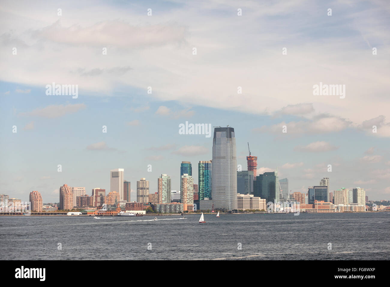 skyline of jersey city with blue sky and white clouds seen from the ...