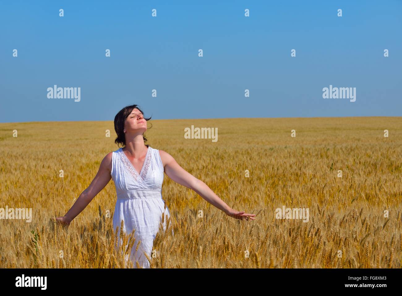 young woman in wheat field at summer Stock Photo - Alamy