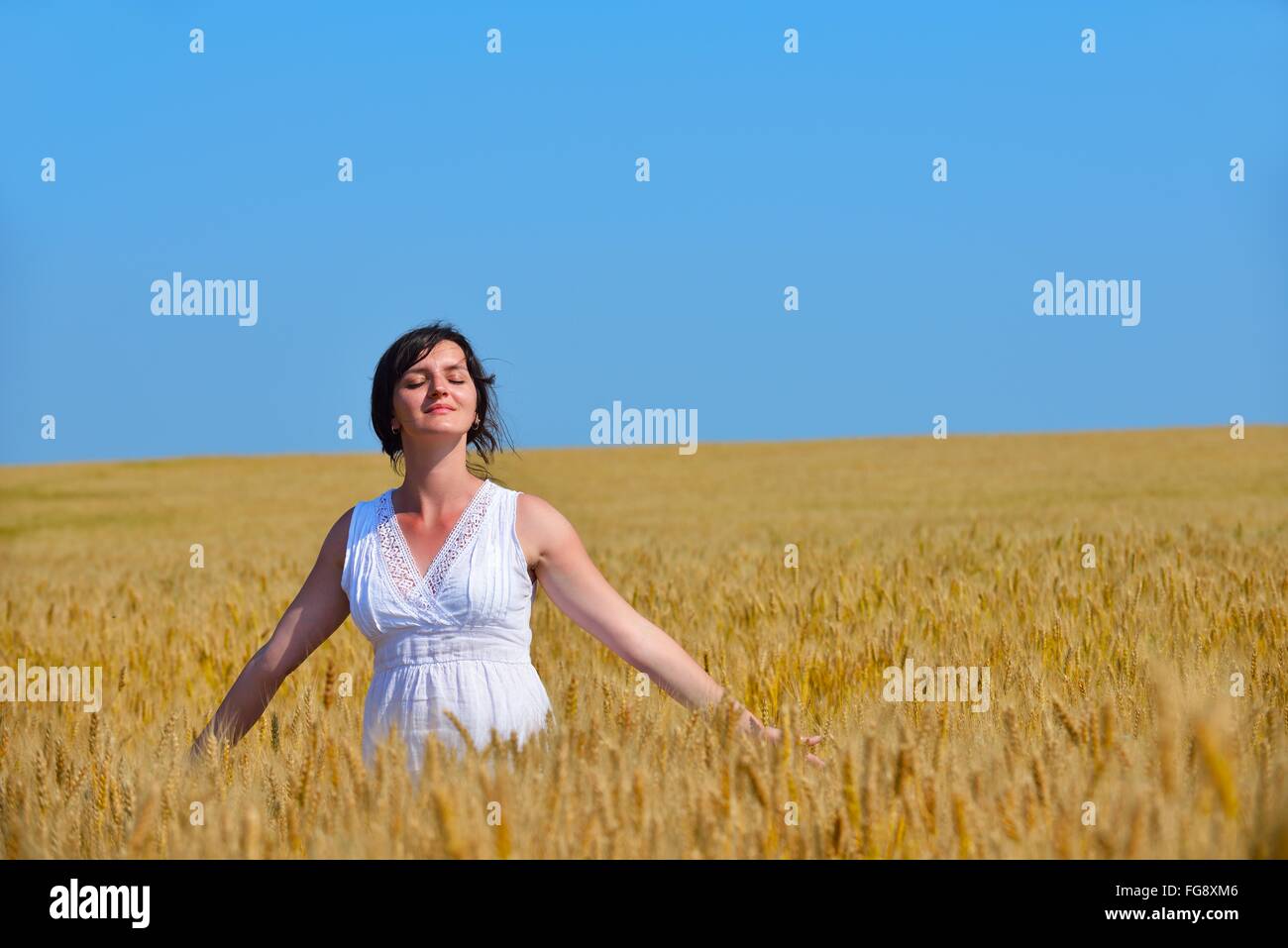 young woman in wheat field at summer Stock Photo - Alamy