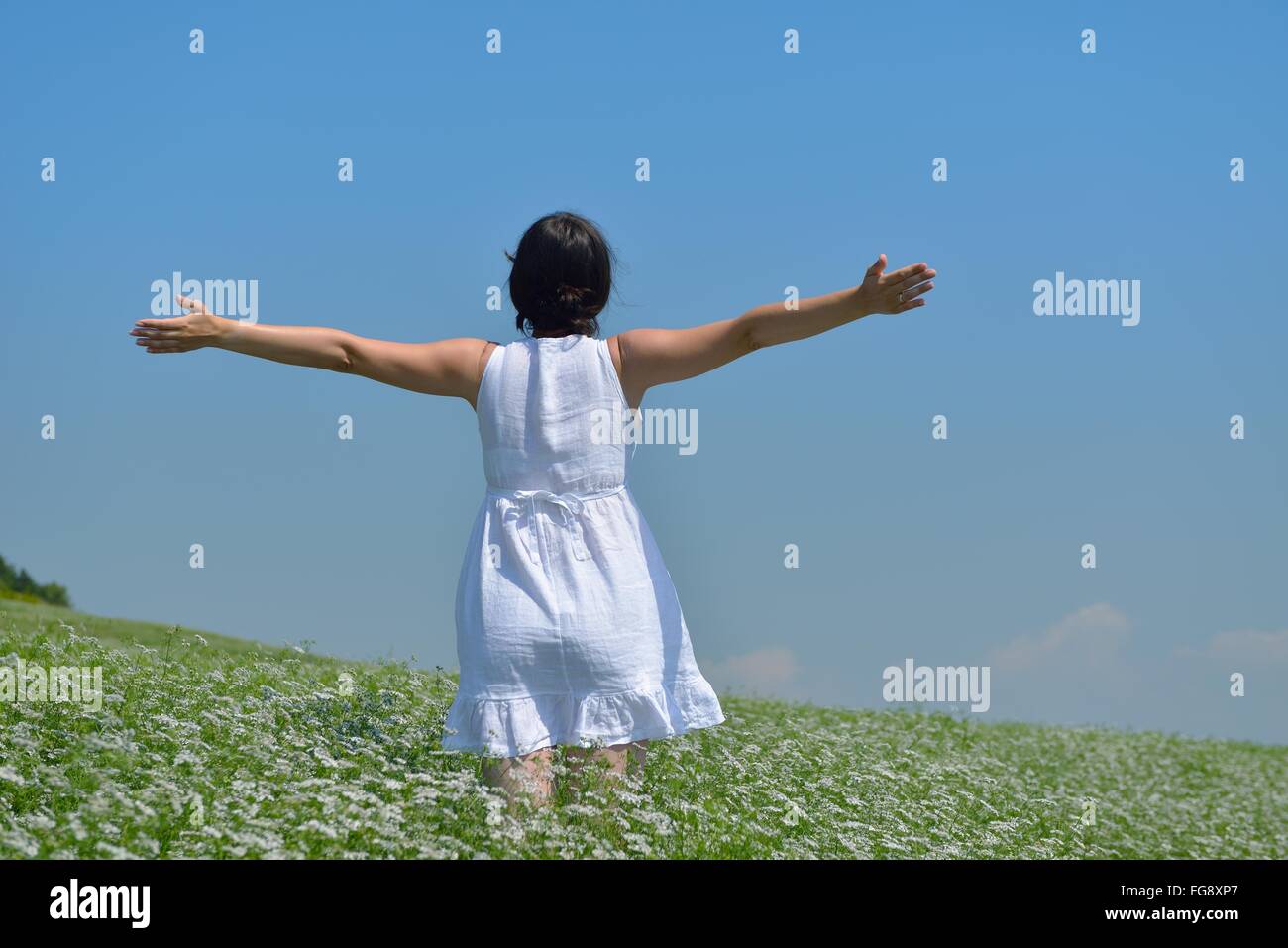 Young happy woman in green field Stock Photo - Alamy