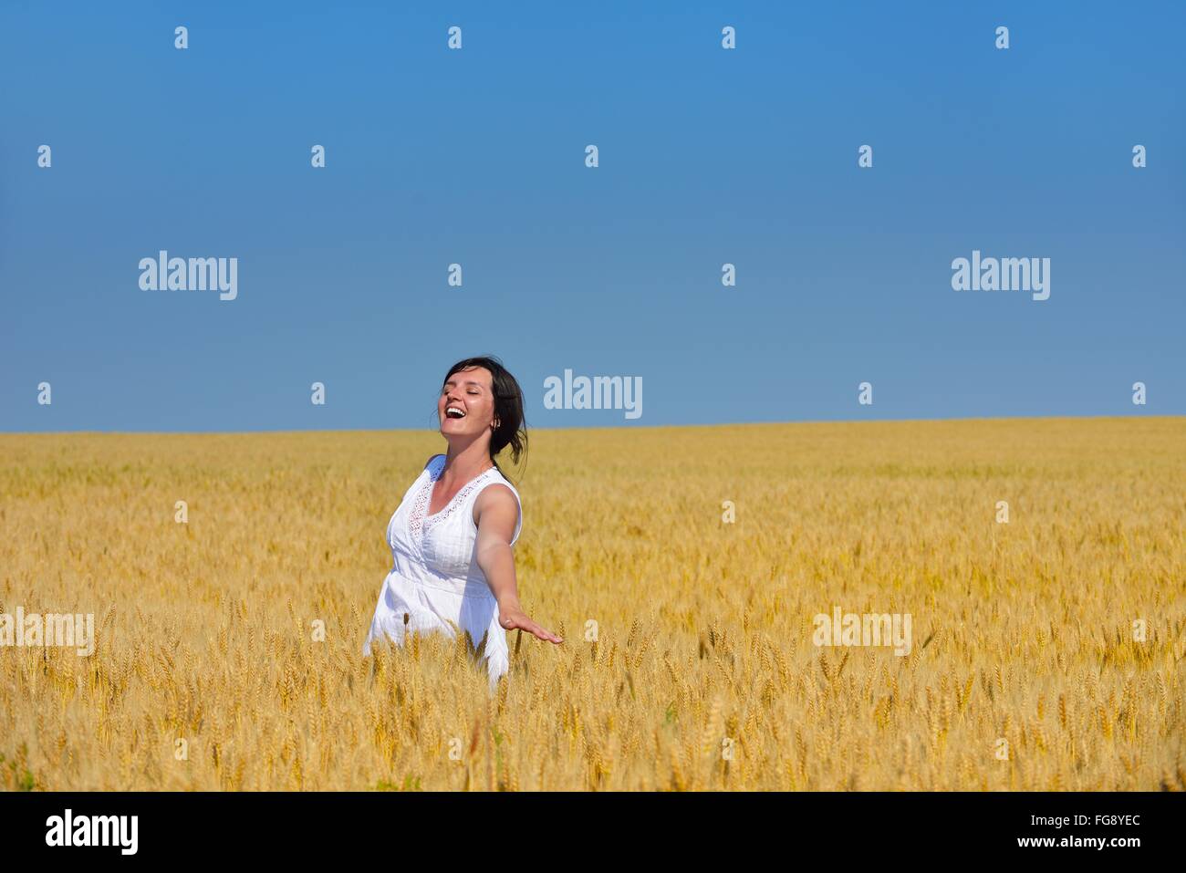 young woman in wheat field at summer Stock Photo - Alamy