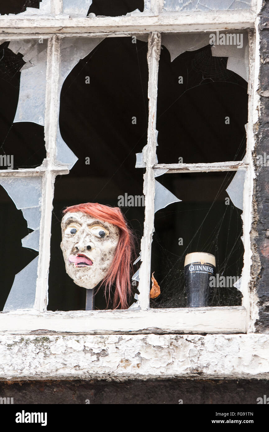 Broken window opposite old Guinness Storehouse with pint of Guinness,and,funny,face,Irish,humour,humour, ,Dublin,Ireland. Stock Photo