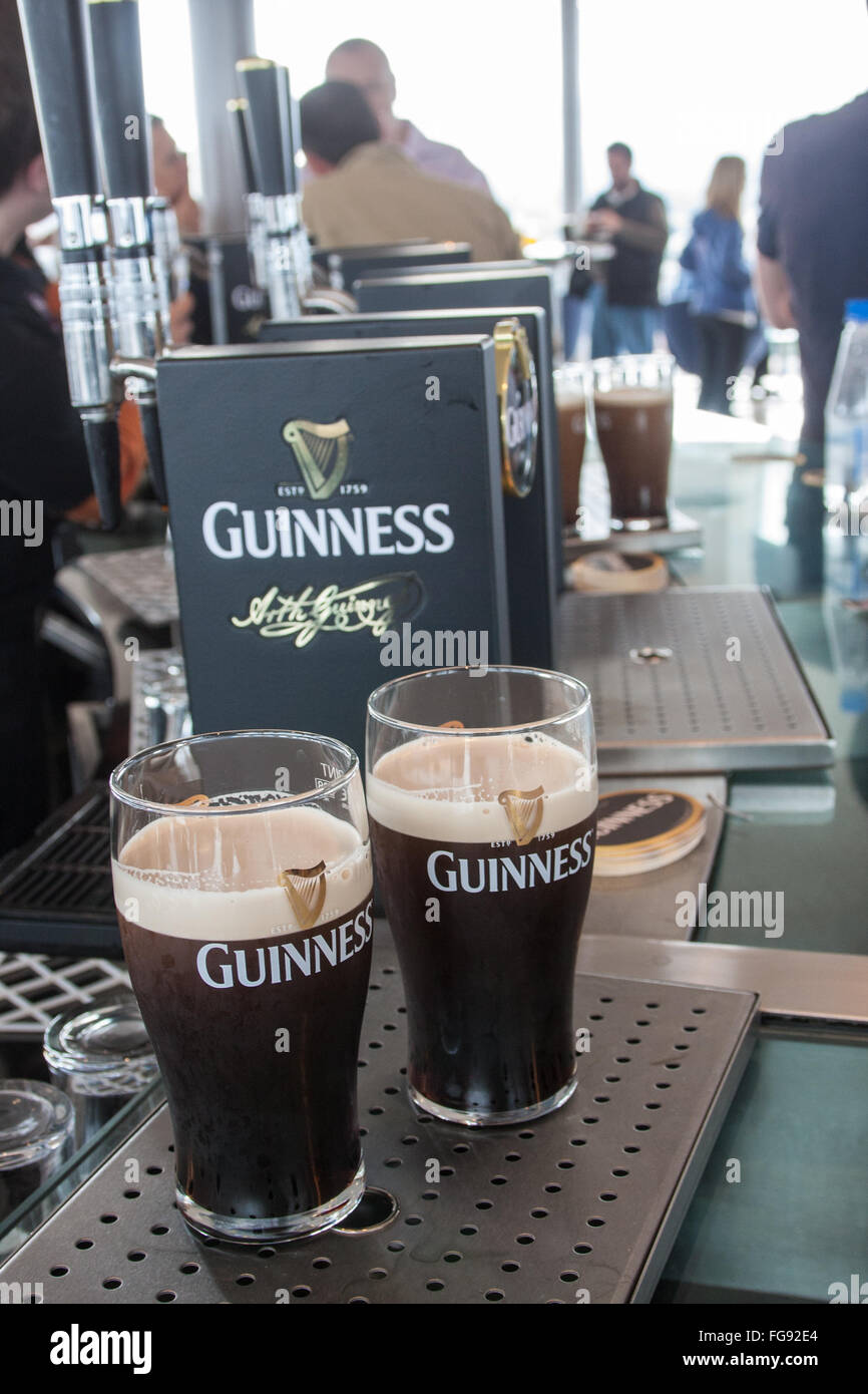 drink,drinking,alcohol,having,a,pint,pint,pints,of,Guinness,at,Interior of old, Guinness,Storehouse,circular,Gravity Bar,Dublin,Ireland.,St Patrick's Stock Photo