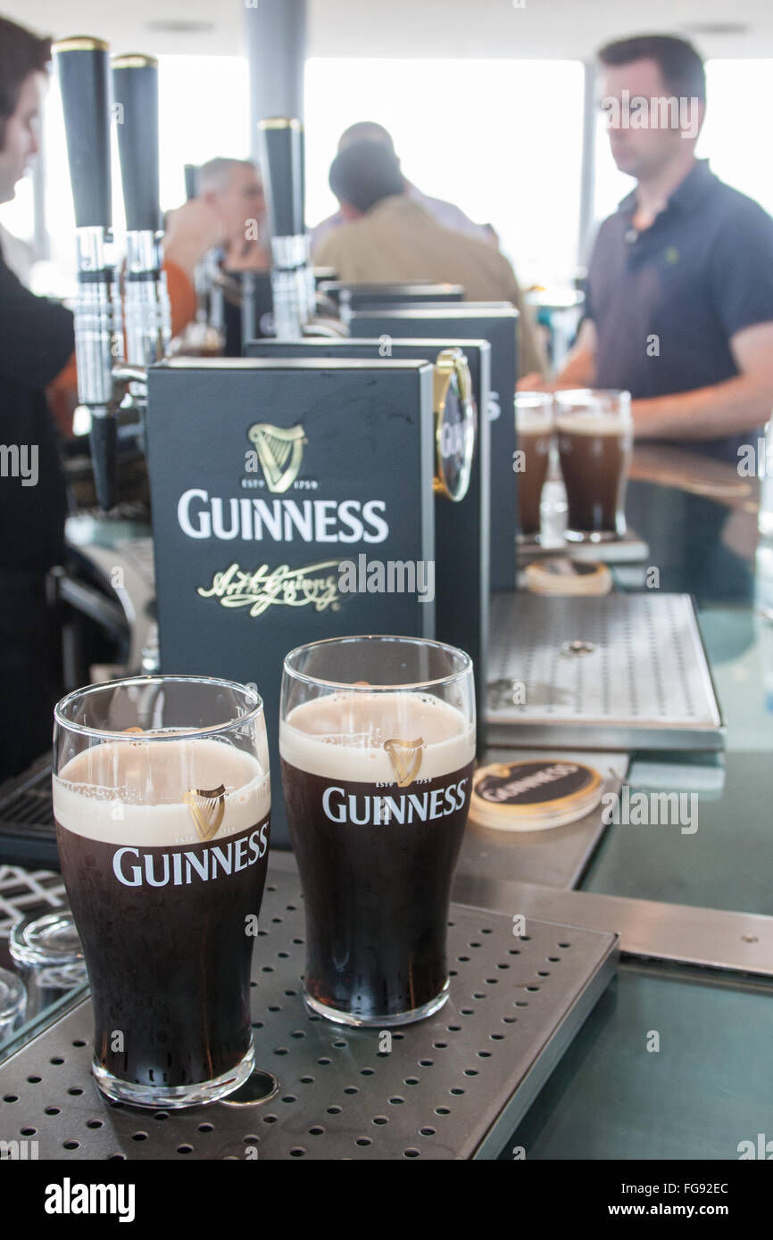drink,drinking,alcohol,having,a,pint,pint,pints,of,Guinness,at,Interior of old, Guinness,Storehouse,circular,Gravity Bar,Dublin,Ireland.,St Patrick's Stock Photo