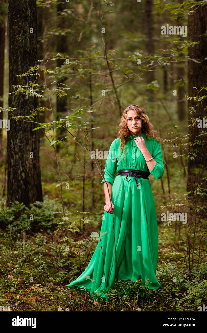 Long-hair girl in green dress at forest Stock Photo - Alamy