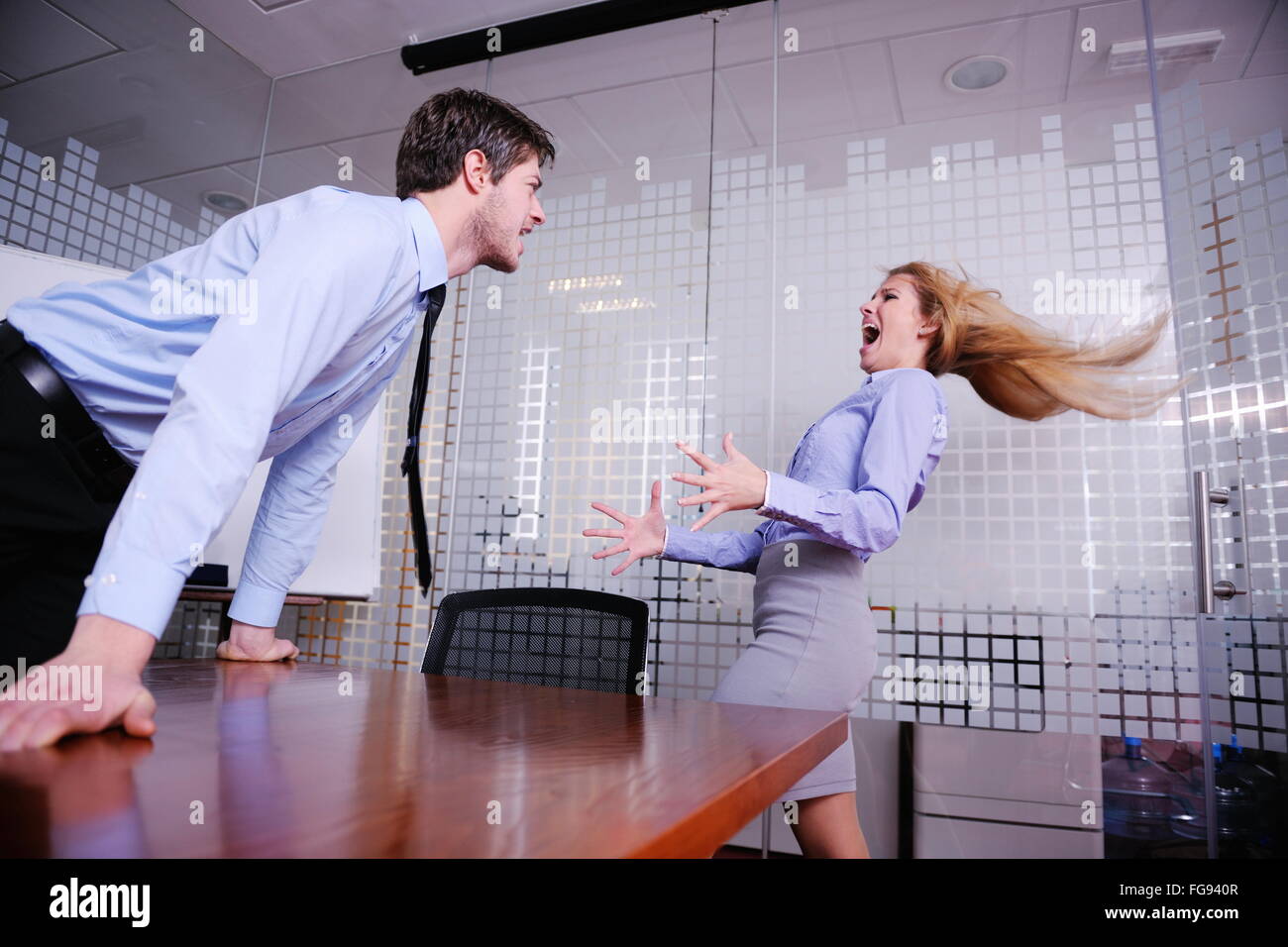 Angry busines sman screaming at employee Stock Photo