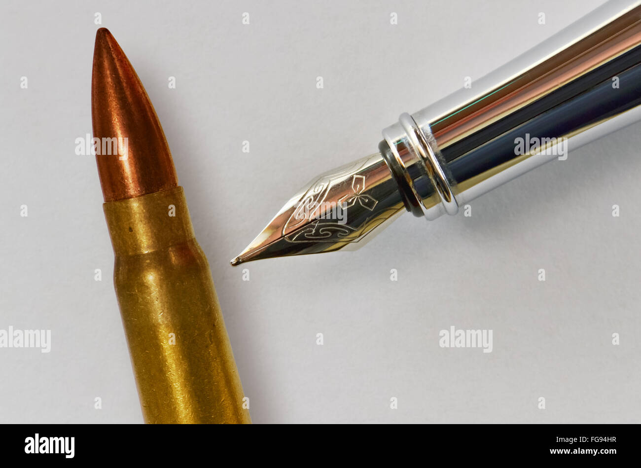 Closeup of the nib of a fountain pen and a bullet Stock Photo