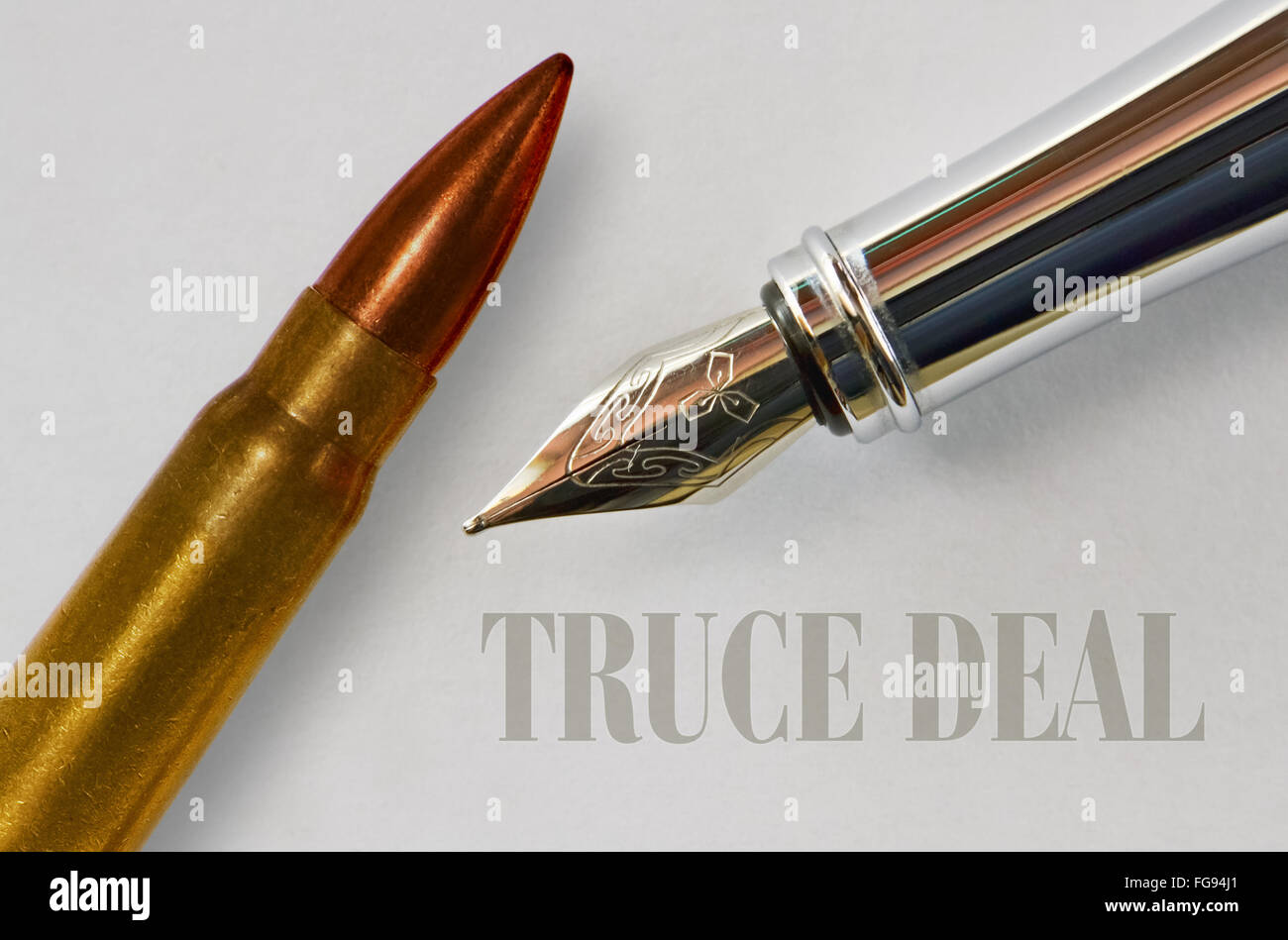 Closeup of the nib of a fountain pen and a bullet and text Truce Deal Stock Photo
