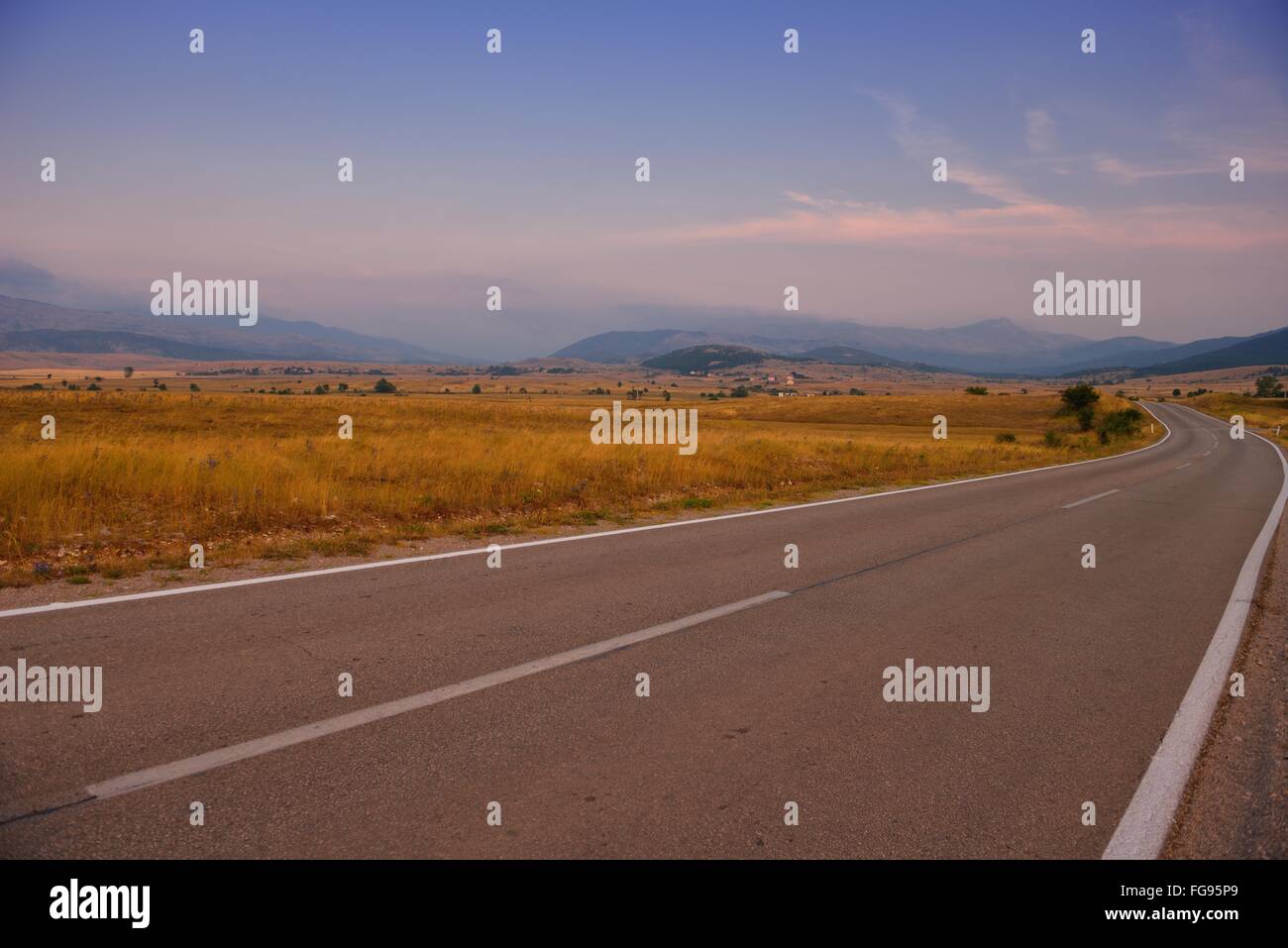 road through the green field Stock Photo - Alamy