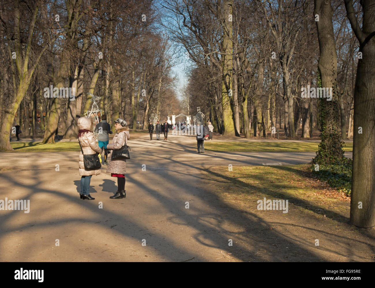 People walking in the Lazienki Royal Park in Warsaw on Sunday, the February morning. EditorialHorizontal view. Stock Photo