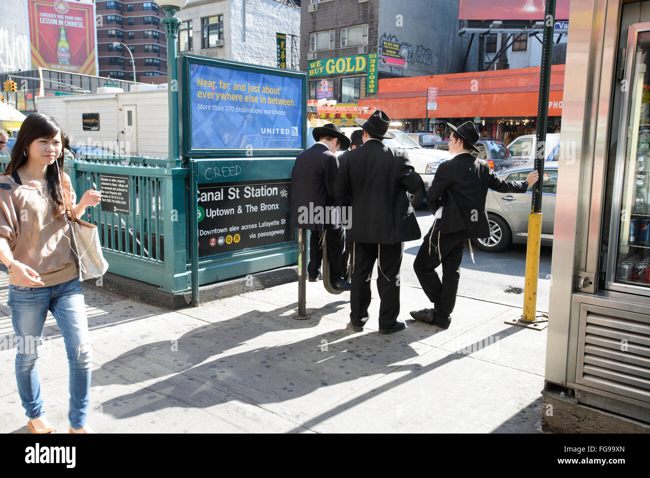 Hasidic/Orthodox Jewish men next to a subway station on Canal Street in New York's Lower East Side Stock Photo
