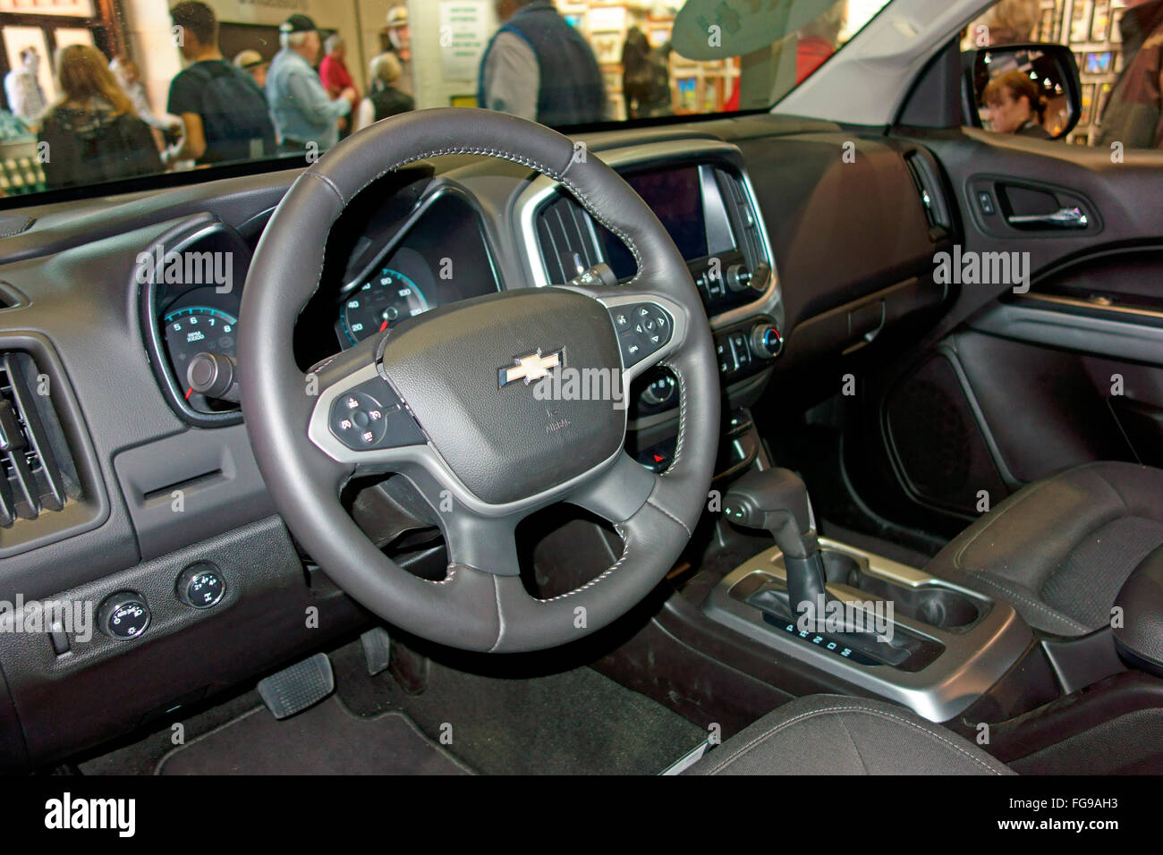 The dash, steering wheel and instruments of a 2016 GMC Chevrolet Chevy Colorado truck automobile Stock Photo