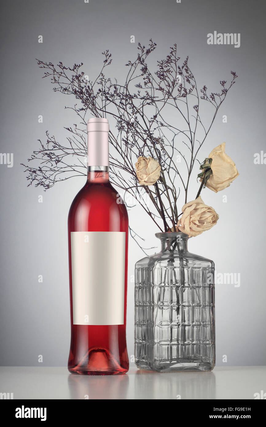 Rose wine bottle with label mockup to withered white roses in a vase Stock Photo Alamy