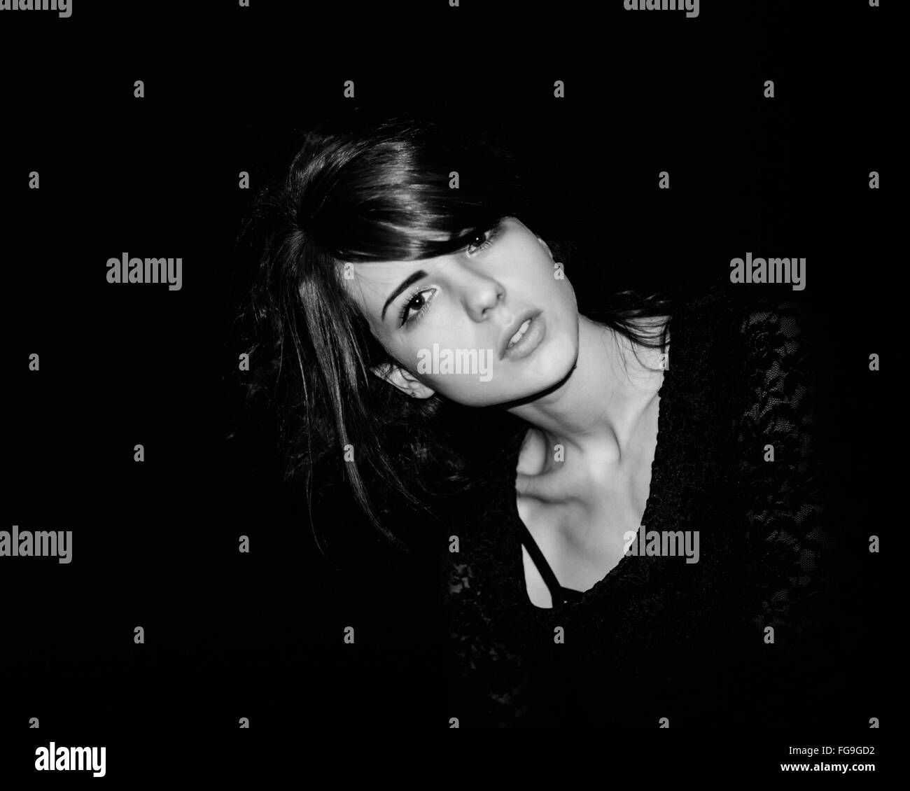 Portrait Of Beautiful Woman Against Black Background Stock Photo - Alamy