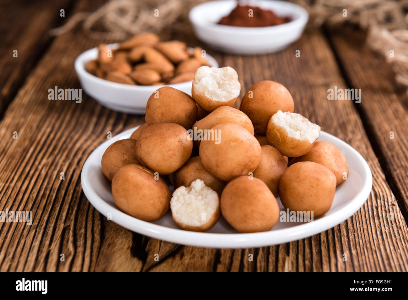 Homemade Marzipan Potatoes (German cuisine) on rustic wooden background Stock Photo