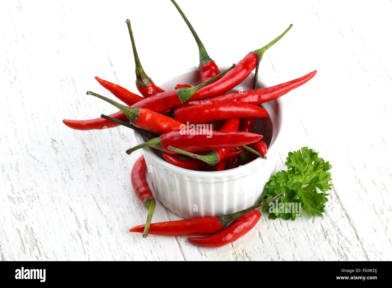 Red hot chili peppers heap on the wood background Stock Photo - Alamy